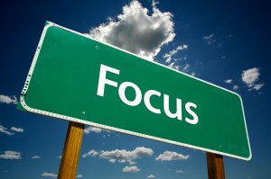 Focus road sign with dramatic blue sky and clouds.